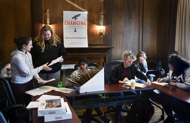 Staff and volunteers get organized at the Changing Homelessness offices on Park Street Wednesday morning before heading out to try and identify homeless young adults for the annual, national homeless count. (Bob Self/Florida Times-Union)