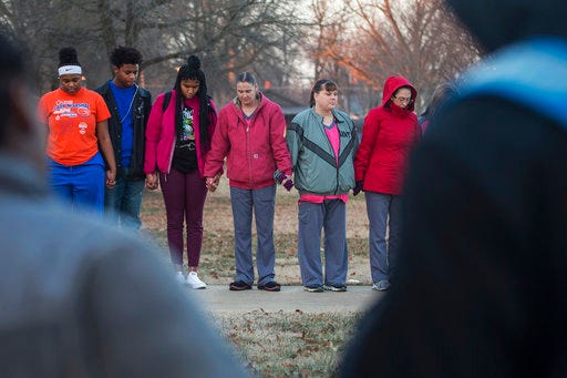 Students and community members hold hands in prayer before classes at Paducah Tilghman High School in Paducah, Ky., Wednesday, Jan. 24, 2018. The gathering was held for the victims of the Marshall County High School shooting on Tuesday. (Ryan Hermens/The Paducah Sun via AP)