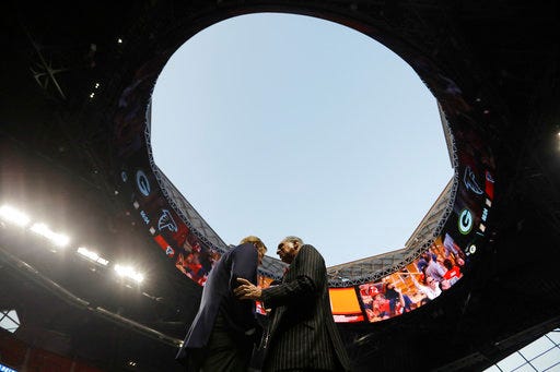 FILE - In this Sept. 17, 2017, file photo, NFL Commissioner Roger Goodell, left, speaks with Atlanta Falcons owner Arthur Blank under the open roof, before an NFL football game between the Falcons and the Green Bay Packers in Atlanta. TheFalcons are expecting the retractable roof to be “fully operational” for the 2018 season and next year’s Super Bowl. Falcons president and CEO Rich McKay told The Associated Press on Wednesday, Jan. 24, 2018, he expects fixes on the roof by the 2018 season “if not well before.” Problems kept the roof closed on the $1.5 billion stadium for most of the 2017 season. The unique roof, designed to open like a camera lens, was open only for the Falcons' first home regular-season game. (AP Photo/David Goldman, File)