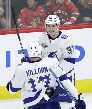 Tampa Bay Lightning's Yanni Gourde (37) celebrates his goal with Alex Killorn during the third period of a game against the Chicago Blackhawks on Monday in Chicago. [AP Photo / Charles Rex Arbogast]