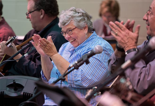 When the music gets lively, Margaret Jackson encourages the audience to join in during the monthly Pickin' and Grinnin' community outreach music program at Center United Methodist Church on Thursday night. The proceeds raised on Thursday night will benefit the Davidson Medical Ministries Clinic. [Donnie Roberts/The Dispatch]