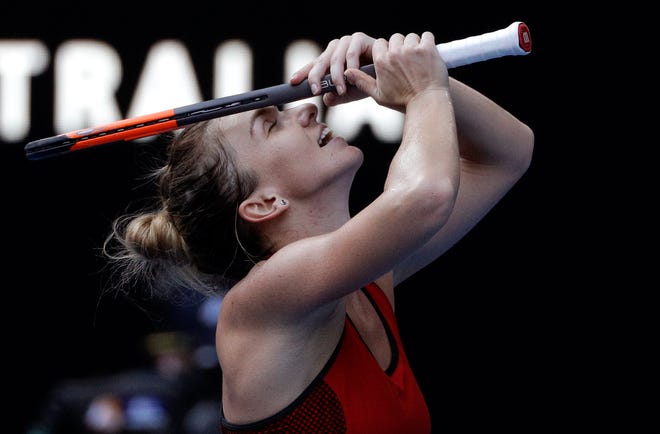 Romania's Simona Halep celebrates after defeating Germany's Angelique Kerber in their semifinal at the Australian Open tennis championships in Melbourne, Australia, Thursday, Jan. 25, 2018. (AP Photo/Dita Alangkara)