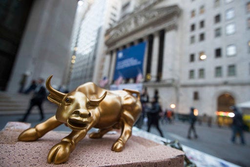 FILE - In this Tuesday, Oct. 25, 2016, file photo, a miniature reproduction of Arturo Di Modica's "Charging Bull" sculpture sits on display at a street vendor's table outside the New York Stock Exchange, in lower Manhattan. The idea of the bull market dying because of central banks tightening too quickly is a concern, according to some experts. (AP Photo/Mary Altaffer, File)