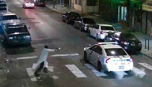FILE - In this Jan. 7, 2016, image made from a video provided by the Philadelphia Police Department, a gunman runs toward a police car driven by Philadelphia police officer Jesse Hartnett in Philadelphia. On Thursday, Jan. 25, 2017, Edward Archer, a man accused of ambushing a Philadelphia police officer with a hail of gunfire in the name of the Islamic State group, refused to cooperate at the start of his attempted murder trial, telling a judge that he won't "plead to anyone but Allah." (Philadelphia Police Department via AP, File)