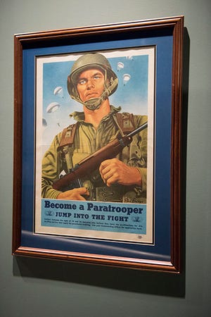 This poster, currently hanging in the Airborne and Special Operations Museum and created in 1944, encourages Soldiers to become paratroopers. “Jump into the fight. Soldiers between the ages of 18 and 32 inclusive, who believe they have the qualifications for this thrilling service, may apply for parachutist training. Ask your command officer for application form.”