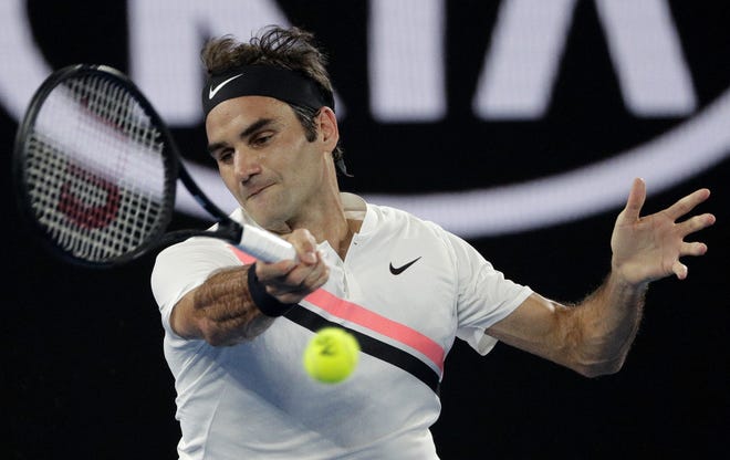 Switzerland's Roger Federer makes a forehand return to South Korea's Hyeon Chung during their semifinal at the Australian Open in Melbourne, Australia, on Friday. [AP Photo / Dita Alangkara]