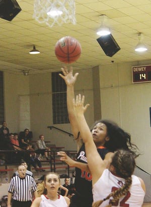 Pawhuska's Rayven Stone (10) shots over Dewey's Hayley Devivo (32) in Thursday's game in Dewey. The Lady Huskies recorded a 46-33 victory over the Lady Bulldoggers.