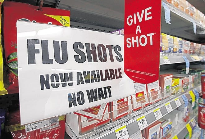 A sign telling customers that they can get a flu shot in a Walgreen store. While hospitals are seeing a spike in flu-related visits nationwide, the Poconos seem to be spared the worst of the season. Officials at Lehigh Valley Hospital- Pocono say they're ready should that change.  [AP Photo/Darron Cummings]