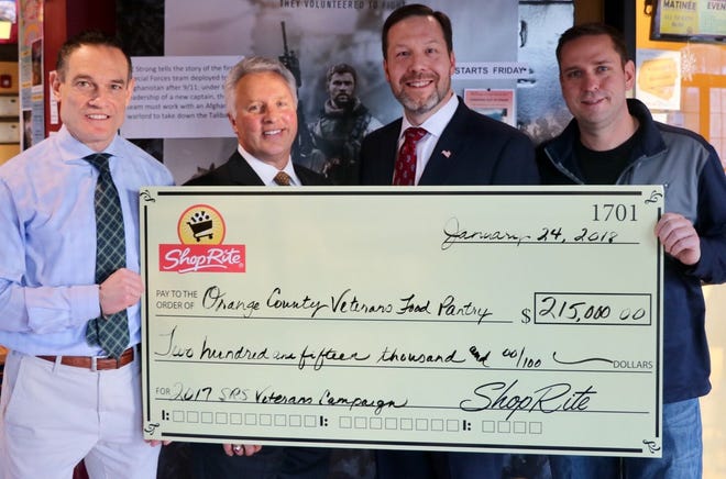 Accepting a check for $215,000 for the Orange County Veterans Food Pantry is Christian Farrell, left, O.C. Veterans Service Agency director, from Brett Wing, president and CEO of ShopRite Supermarkets, Tom Urtz, ShopRite's vice president of operations, and Orange County Executive Steve Neuhaus. [Photo provided]