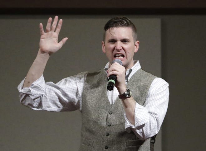 FILE - In this Dec. 6, 2016, file photo, Richard Spencer speaks at the Texas A&M University campus in College Station, Texas. Spencer's campus tour organizer is suing the University of Cincinnati's president, saying the school wouldn't rent space for Spencer to speak on campus unless a nearly $11,000 security fee was paid. An attorney for Spencer and the organizer says requiring such payment because a speaker is controversial or prompts hostile reaction is discriminatory and unconstitutional. (AP Photo/David J. Phillip, File)