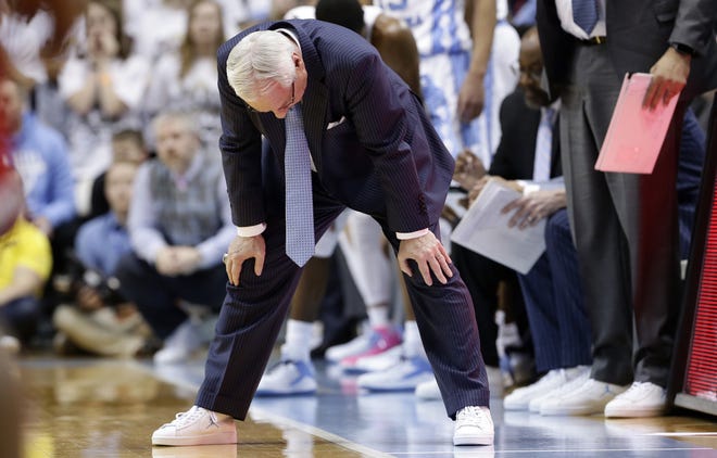 North Carolina coach Roy Williams puts his hands on his knees after a play in the second half of Saturday's overtime loss to N.C. State. The Tar Heels made only 4 of 19 from 3-point range and 11 of 20 from the foul line. [Gerry Broome/The Associated Press]
