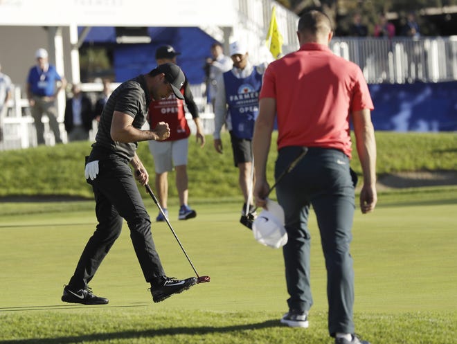 Jason Day, of Australia, left, reacts after making his putt on the 18th hole of the South Course at Torrey Pines Golf Course to win the Farmers Insurance Open during a playoff Monday in San Diego. [AP Photo / Gregory Bull]
