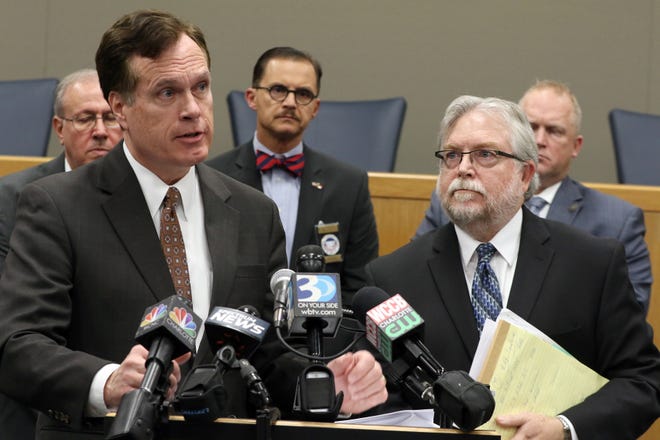 Attorney Garry Whitaker, with attorney Paul Coates to his left, talks to the media during an opioid litigation press conference held Monday, Jan. 29, 2018, at the Gaston County Courthouse in Gastonia, N.C. [Mike Hensdill/The Gaston Gazette]