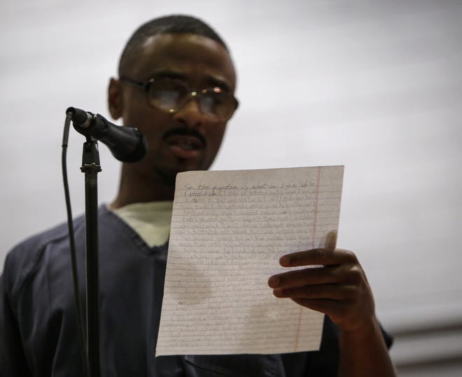In this Tuesday, Dec. 5, 2017 photo, inmate Kahri Smith reads a poem at the Richard A. Handlon Correctional Facility in Ionia, Mich., as part of the Free Verse Arts Project Poetry Slam. Inmates and students from Michigan State University's Residential College in the Arts and Humanities met weekly for a semester to learn about and write poetry. Smith is serving a sentence for second-degree homicide. (Matthew Dae Smith /Lansing State Journal via AP)