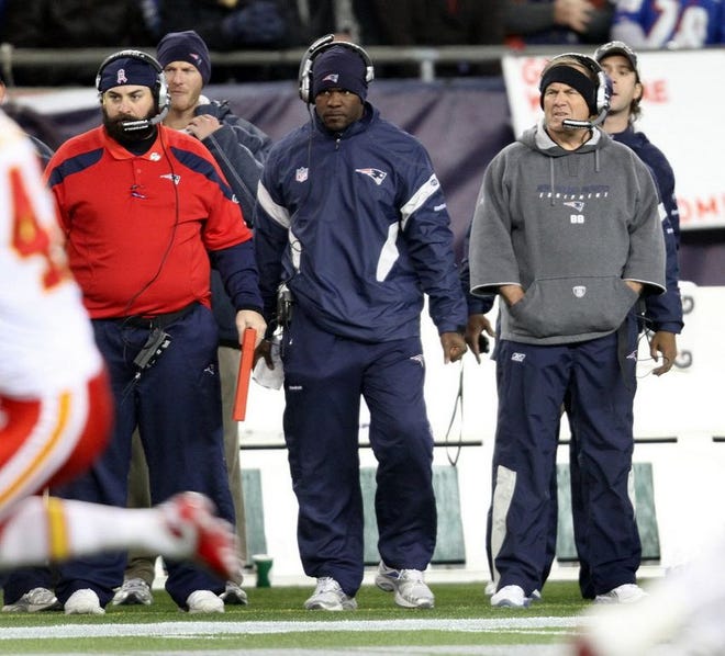 Brian Flores, center, is flanked by defensive coordinator Matt Patricia, left, and Bill Belichick, during a game at Gillette Stadium. Flores is the leading candidate to replace Patricia.