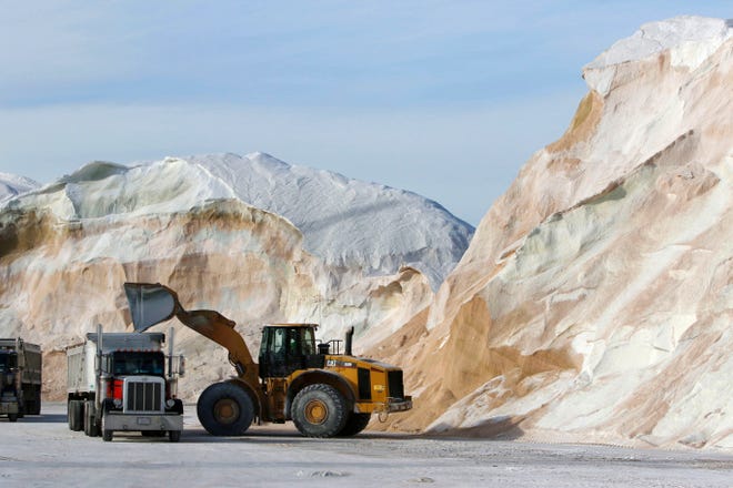 In this January file photo, road salt is loaded into trucks at Eastern Minerals Inc., in the Boston suburb of Chelse. Scientists are starting to raise concerns about road salt's impact on the environment, especially drinking water, because lakes and streams near roads are showing elevated levels of sodium and chloride. [BILL SIKES/AP PHOTO]