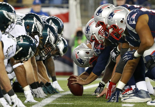 FILE - In this Dec. 6, 2015, file photo, the New England Patriots, right, and the Philadelphia Eagle get set for the snap at the line of scrimmage during an NFL football game at Gillette Stadium in Foxborough, Mass.

 The two teams are set to meet in Super Bowl 52 on Sunday, Feb. 4, 2018, in Minneapolis. (Winslow Townson/AP Images for Panini via AP, File)