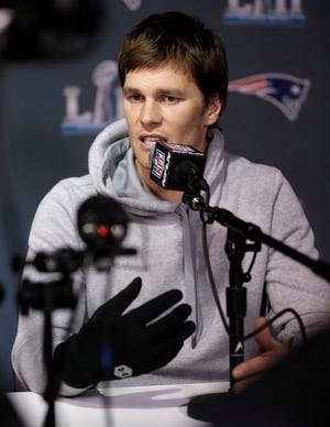 Tom Brady wears a glove on his injured right hand as he answers questions during a news conference Tuesday, Jan. 30, 2018, in Minneapolis. The Patriots are scheduled to face the Philadelphia Eagles in the NFL Super Bowl 52 football game Sunday, Feb. 4.