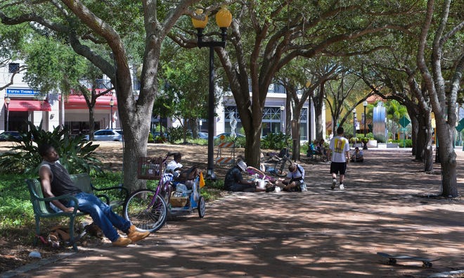 Homeless rest at Five Points Park in Sarasota on Tuesday. Herald-Tribune staff photo / Dan Wagner