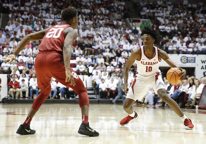 Alabama guard Herbert Jones (10) dribbles the ball guarded by Oklahoma Kameron McGusty (20) during the first half of a game against No. 12 Oklahoma at Coleman Coliseum on Saturday, Jan. 27, 2018. [Staff Photo/Erin Nelson]