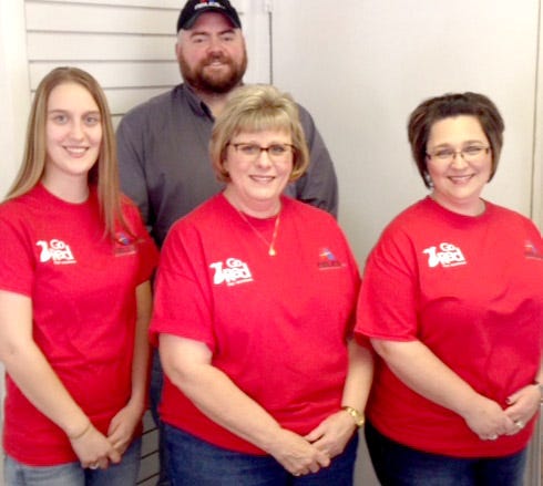 Wearing red at the Zanesville office of Ables Heating, Cooling, Electric & Refrigeration are: Jeremy Ables in the back row and Megan Wright, Margo Brooks and Natasha Cox in the front row.