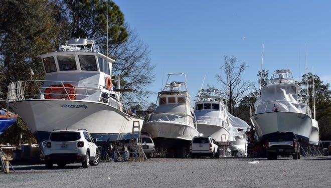 More than a dozen of Destin's charter boats were at the Fisherman's Boat Yard in Freeport recently getting ready for the upcoming season. [TINA HARBUCK/THE LOG]
