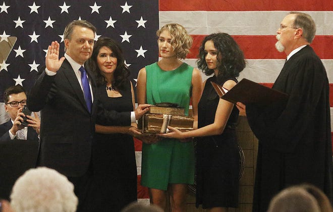 With the help of his wife and two daughters, Jeffrey William Colyer is sworn in Wednesday at the Statehouse by Kansas Chief Justice Lawton Nuss to become Kansas' 47th governor, succeeding Gov. Sam Brownback. [Thad Allton/The Capital-Journal]