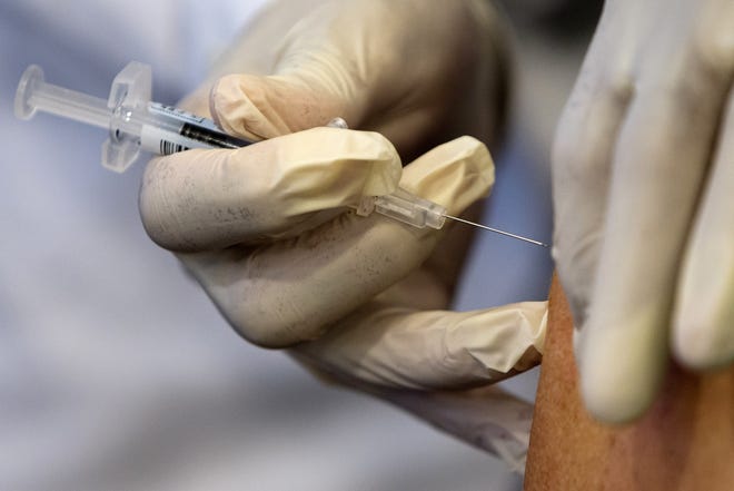 A nurse administers a flu vaccine shot.[AP FILE]