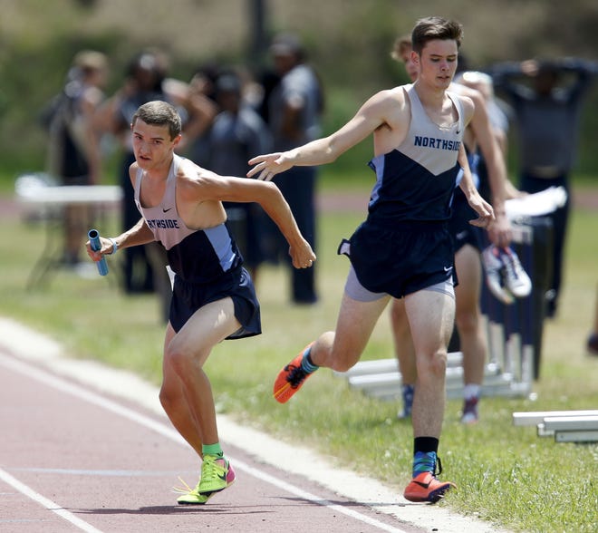 Northside runner Tanner King takes the baton from Samuel Barrentine as they compete in the 4x800 relay during the West Alabama Track and Field Championship meet April 20, 2017 at Paul Bryant High School in Tuscaloosa. King won two events last week in Birmingham at the Last Chance Invitational. [Staff Photo/Gary Cosby Jr.]