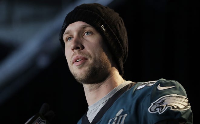 Eagles quarterback Nick Foles listens to a question from the press Thursday in the runup to Super Bowl 52 in Minneapolis. Foles' breakout performance in the postseason has boosted demand for his jerseys and bobbleheads. [ERIC GAY / THE ASSOCIATED PRESS]