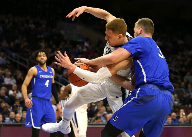 Villanova guard Donte DiVincenzo is fouled by Creighton forward Toby Hegner during the second half of Thursday's game. (RICH SCHULTS / ASSOCIATED PRESS)