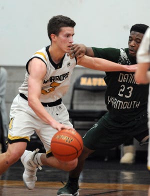 Charlie Campbell of Nauset, left, here driving on Jaquan Phillips of Dennis-Yarmouth in a game last month, has established himself as a dynamic scorer and a true leader.  [Ron Schloerb/Cape Cod Times]
