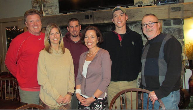 The new Greencastle Golf Club team stands in front of the fireplace in the Fireside Pub. From left: owners Dave and Jen Swam; Mark White, superintendent; Beth Powers, owner; Ben Powers, golf pro; and Ron Powers, owner. SHAWN HARDY/ECHO PILOT.
