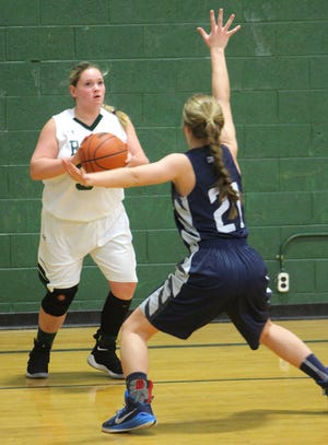 Samantha Brown, of North Adams-Jerome, looks for an outlet as Lauryn Mekelburg, of Hillsdale Academy, plays defense during a Rams-hosted game on Thursday night. [ANDREW KING PHOTO]