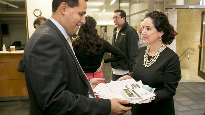 Marisa Barreda Lipscher presents a silver platter of handwritten letters to Mayor Steve Adler’s chief of staff John-Michael Cortez on Wednesday, the day before the controversial development of the Champion tract was coming back to the City Council. JAY JANNER / AMERICAN-STATESMAN