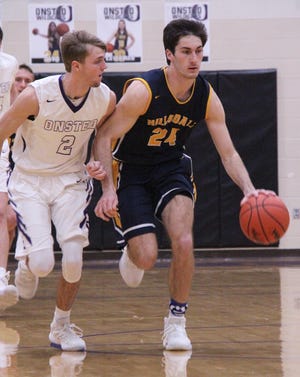 Hillsdale senior Bryce Drews brings the ball upcourt quickly while being closely guarded by an Onsted defender. [MATTHEW LOUNSBERRY PHOTO]