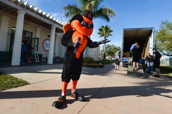 Under the watchful eye of the Oriole Bird, crews for the Baltimore Orioles unload spring training gear Friday at Ed Smith Stadium. [HERALD-TRIBUNE STAFF PHOTO / DAN WAGNER]