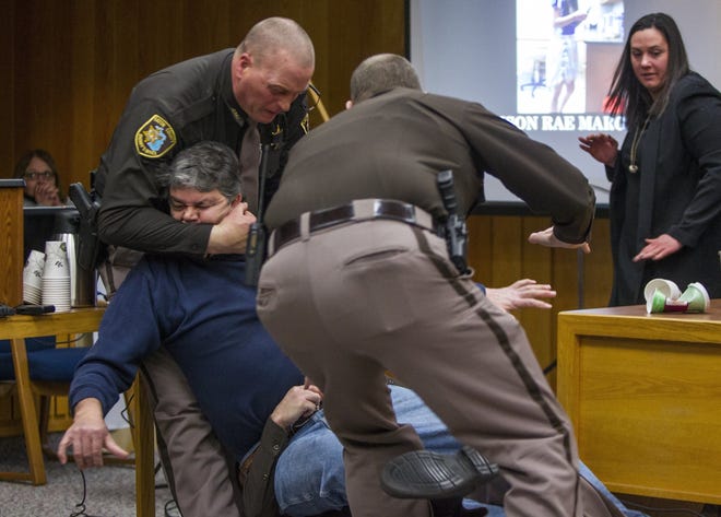 Eaton County Sheriff's deputies restrain Randall Margraves, father of three victims of Larry Nassar, Friday, Feb. 2, 2018, in Eaton County Circuit Court in Charlotte, Mich. The incident came during the third and final sentencing hearing for Nassar on sexual abuse charges. The charges in this case focus on his work with Twistars, an elite Michigan gymnastics club.  (Cory Morse/The Grand Rapids Press via AP)