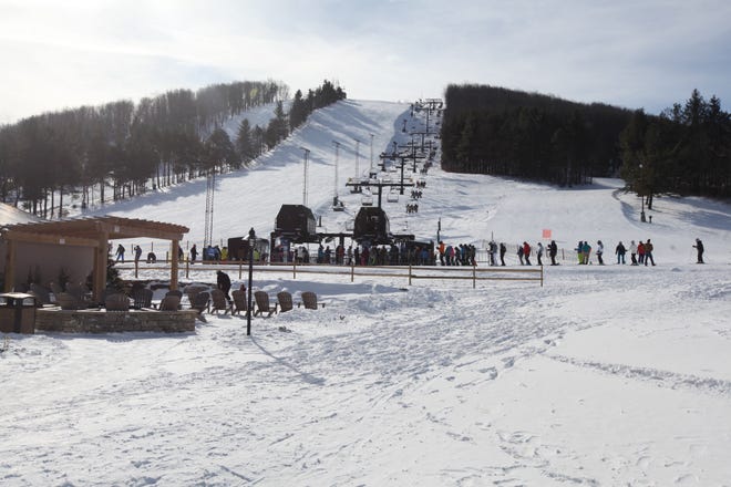 Skiers and snowboarders await a trip up the mountain at Wisp Resort, McHenry, Maryland. [Steve Stephens]