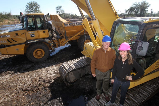 Security First Insurance CEO Locke Burt and his daughter, Melissa Burt DeVriese, chief administrative officer and general counsel, are seen on Tuesday Jan. 30, 2018 on the site of company's future 48-acre headquarters campus at Ormond Crossings in Ormond Beach. Thirteen acres have already been cleared with a ground-breaking ceremony set for March 7. [News-Journal/David Tucker]