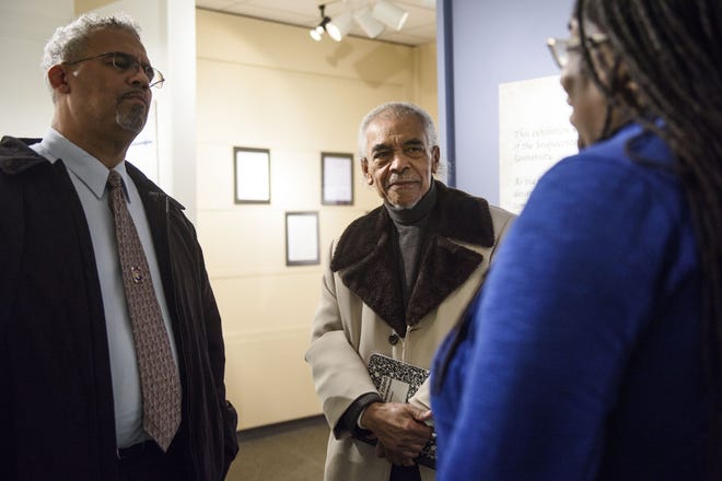 John Caldwell, left, Jerry Woodson and Nicholle Young talk Saturday while visiting an exhibit at the Museum of the Cape Fear highlighting Fayetteville State University's history. [Melissa Sue Gerrits/The Fayetteville Observer]
