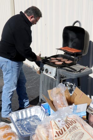 Jay Lynch, Spirit 106.3 general manager, flips burgers for the Community Services Clearinghouse 25th anniversary celebration and canned food drive at the Clearinghouse, 4420 Wheeler Ave., on Friday, Feb. 2, 2018. The Clearinghouse is in dire need for non-perishable items for the food pantry. The Clearinghouse works with area churches, civic groups and community agencies to assist working families in crisis as well as the elderly and disabled. The Clearinghouse programs are designed to help families in emergency situations, elderly or disabled individuals facing unexpected expenses and children in need. Clearinghouse programs specifically target hunger, and a diverse group of children's issues. [JAMIE MITCHELL/TIMES RECORD]