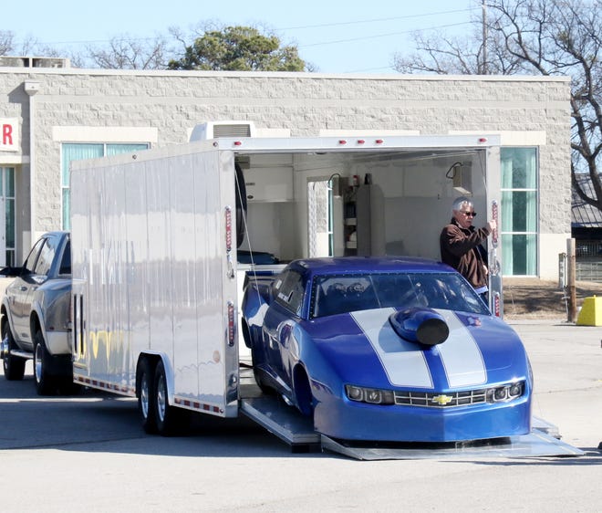 Marc Tate unloads his 2013 Camero dragster for the Arklahoma Motorsports Expo and Tradeshow at Kay Rodgers Park Expo Center, 4400 Midland Blvd. on Friday, Feb. 2, 2018. The show will be Saturday, Feb. 3, 2018 from 9 a.m. to 4 p.m. and will feature motorsports from the Arklahoma area with over 70 vehicles displayed including dirt cars, drag cars, rat rods, antique cars, dirt bikes, rock crawlers and 20 vendors on site. Cost is $5 per person with children 11 and under free. [JAMIE MITCHELL/TIMES RECORD],