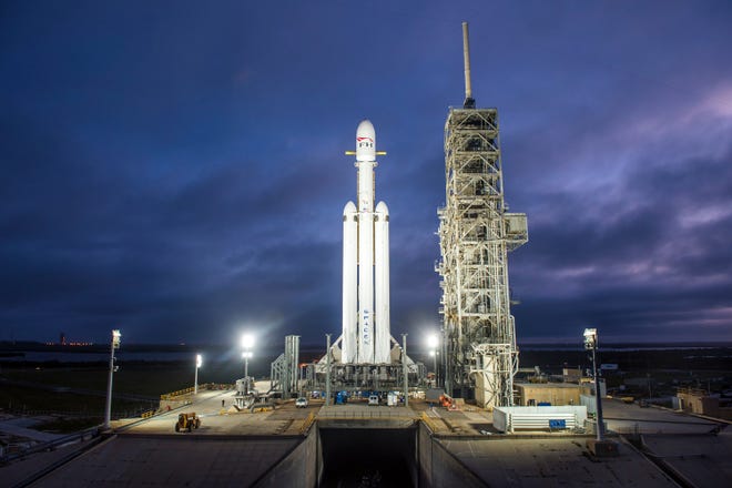 This Dec. 28, 2017 photo shows a Falcon Heavy rocket in Cape Canaveral. With more than 5 million pounds of liftoff thrust the Heavy will be capable of lifting super-size satellites into orbit and sending spacecraft to the moon, Mars and beyond. [SpaceX via AP]
