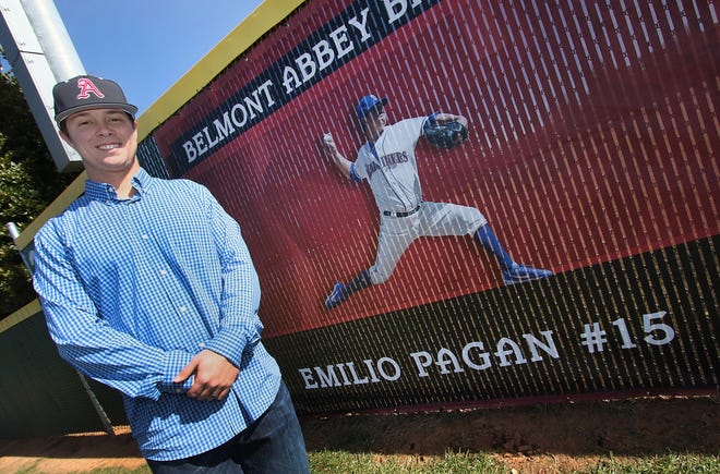 Former Belmont Abbey baseball player Emilio Pagan poses next to his outfield image prior to a game against Newberry College Saturday afternoon. [Mike Hensdill/The Gaston Gazette]