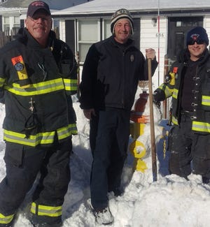 Quincy Fire Lt. James Bailey and firefighters Jim McCarthy and Tom Callanan shovel hydrants on Sea St in Quincy after the second in a series of snowstorms in 2015. (Jim Mccarthy)