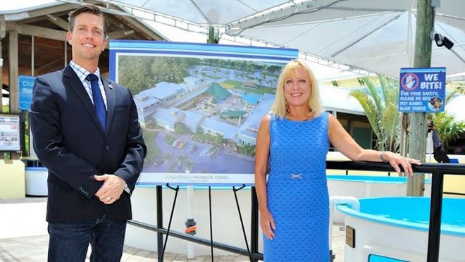 Jack Lighton, Loggerhead Marinelife Center president and chief executive officer and Lynne Wells, LMC s capital campaign director are shown here with a rendering of LMC's planned expansion.
