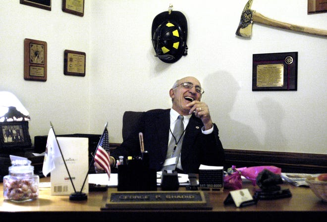 Surrounded by tokens of appreciation, Sen. George Shadid leans back and lets out a laugh in his Senate office at the Capitol building in 2006. As assistant majority leader, his seniority afforded him a spacious office compared to other senators. ADAM GERIK/JOURNAL STAR