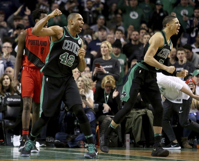 Al Horford and Jayson Tatum had a lot to celebrate after beating Portland on Sunday. [Mary Schwalm/The Associated Press]