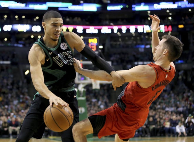 Jayson Tatum drives against Blazers guard Pat Connaughton during the second half of Sunday's game. [Mary Schwalm/The Associated Press]